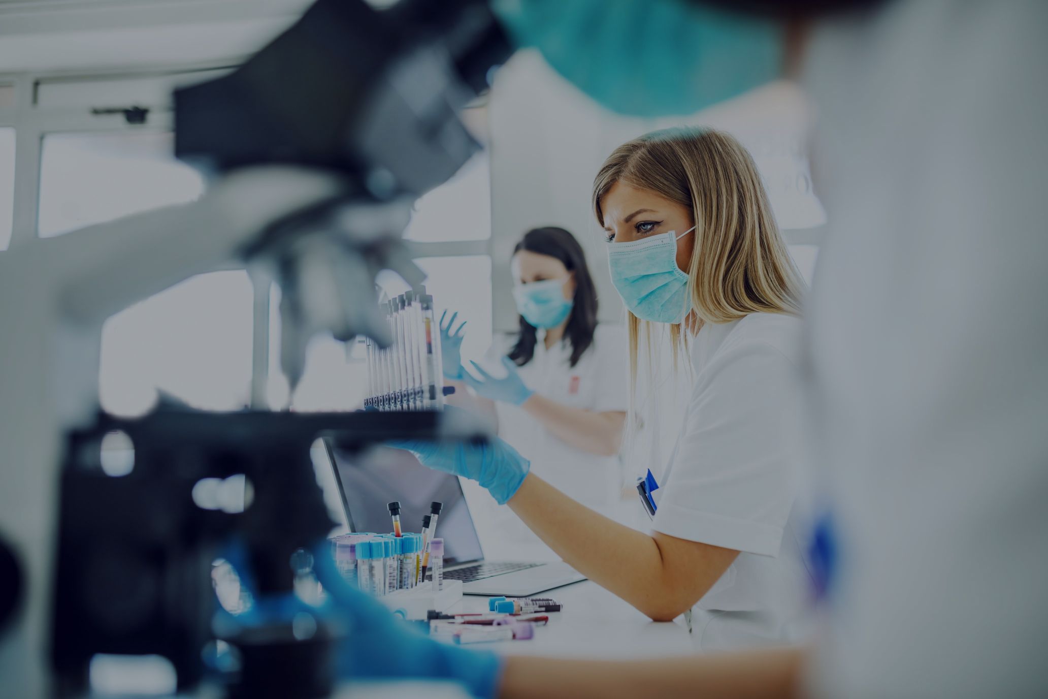 Scientist in lab using microsopes